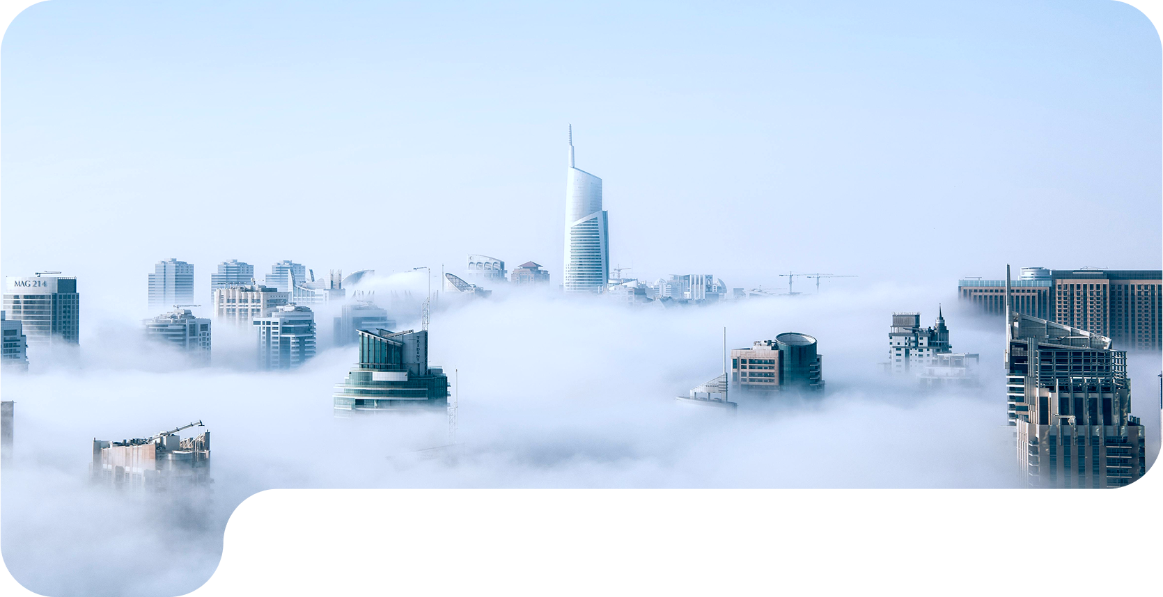 City skyline rising above the clouds